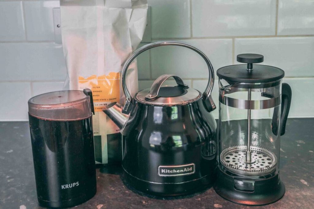 french press, kettle grinder and coffee