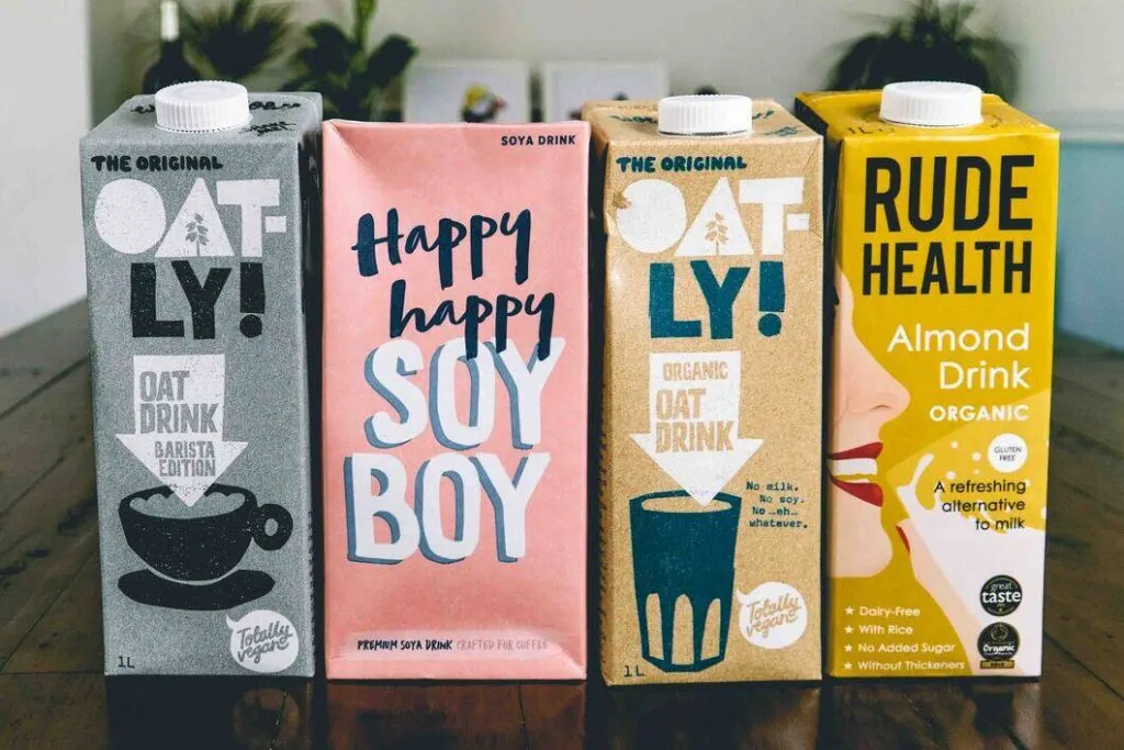 Oatly Barista, Happy Happy Soy, Organic Oatly and Rude Health Almond Milk in a line
