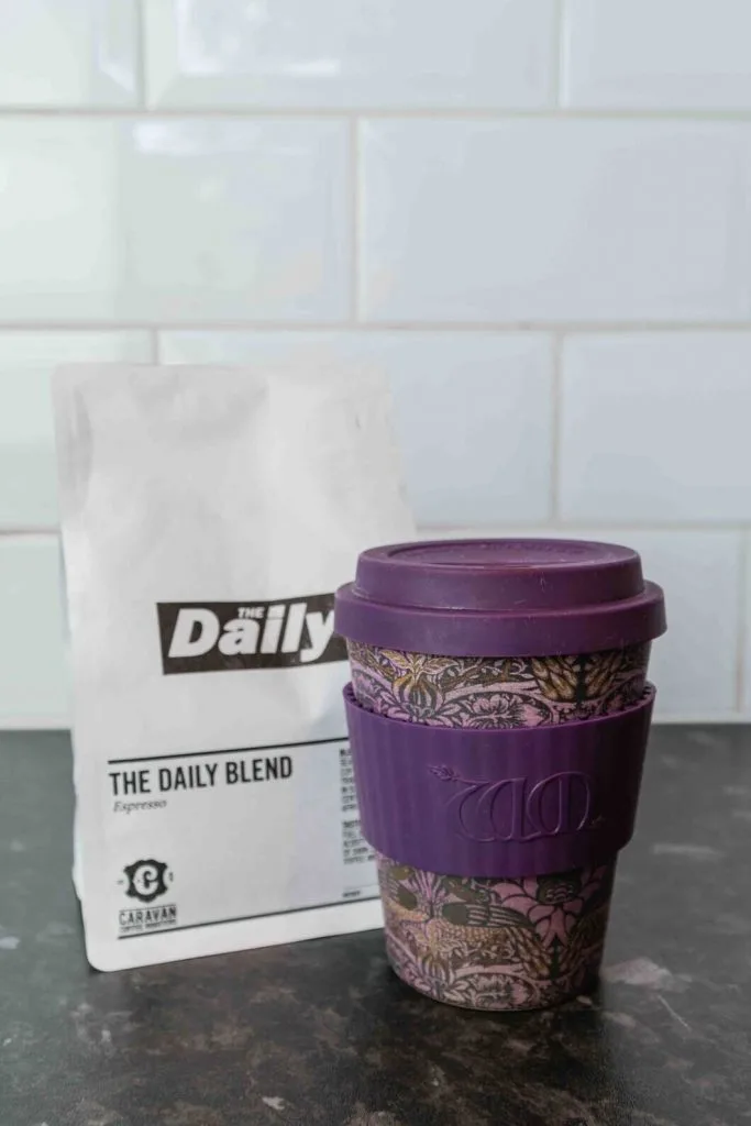 coffee cup with a lid to keep coffee warm and bag of coffee beans