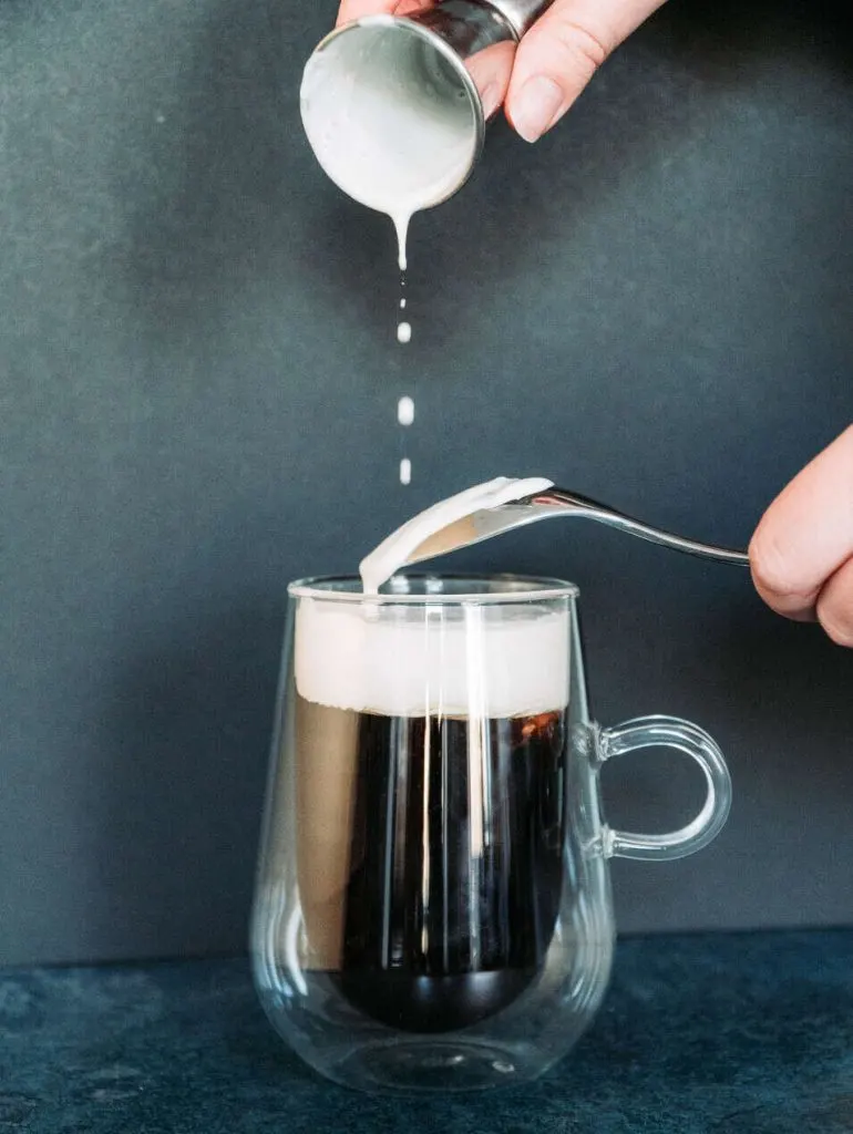 Pouring the Bailey's Cream on the Coffee