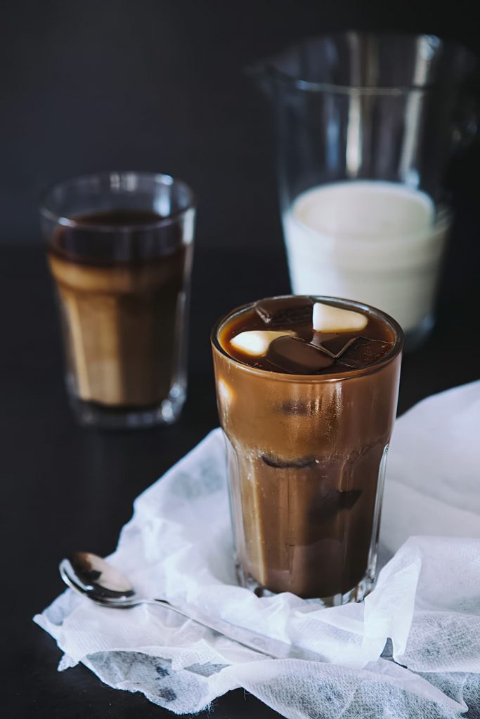Iced coffee with chocolate cubes and fresh milk