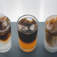 different iced coffee with toddy palm, orange, and coconut milk