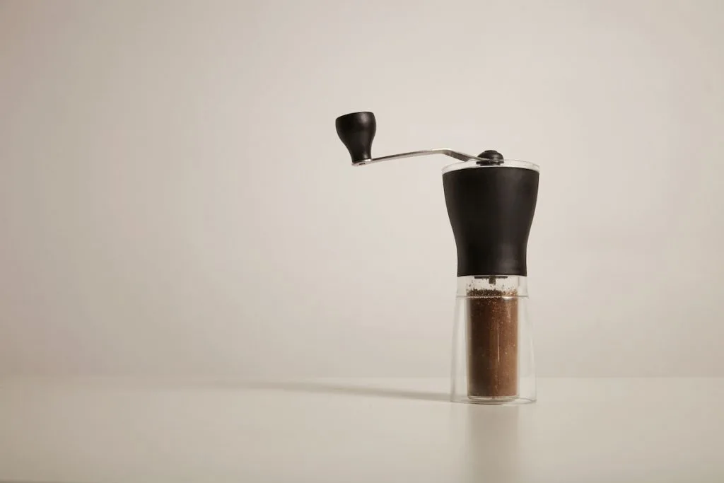 Manual grinder with freshly ground coffee