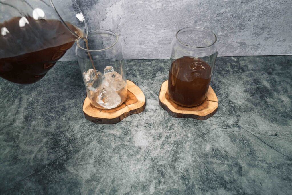 Ice in a glass with japanese iced coffee being poured over