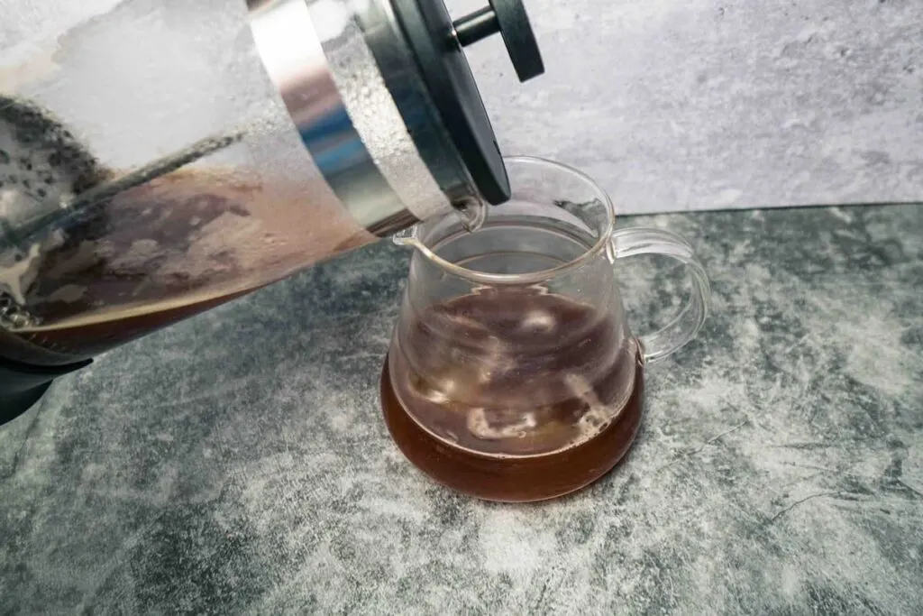 french press coffee being poured over ice