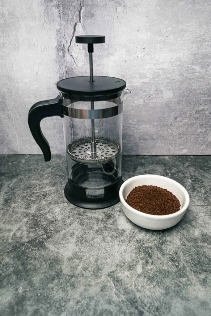 ground coffee next to french press